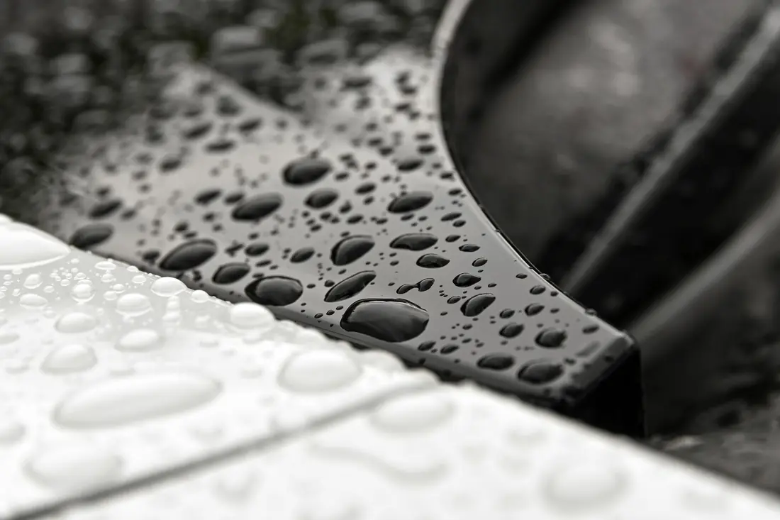 Water droplets beading on paint
