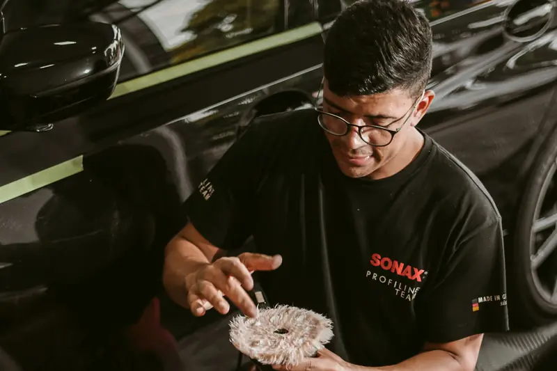 A person holding a corded polisher